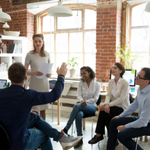 Woman presenting a paper to group