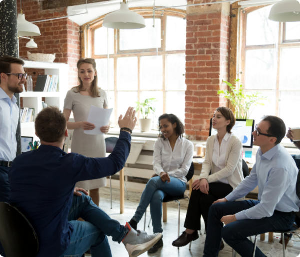 Woman presenting a paper to group