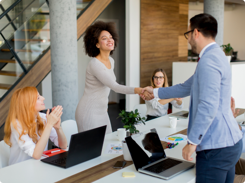 Woman shaking hands with a man